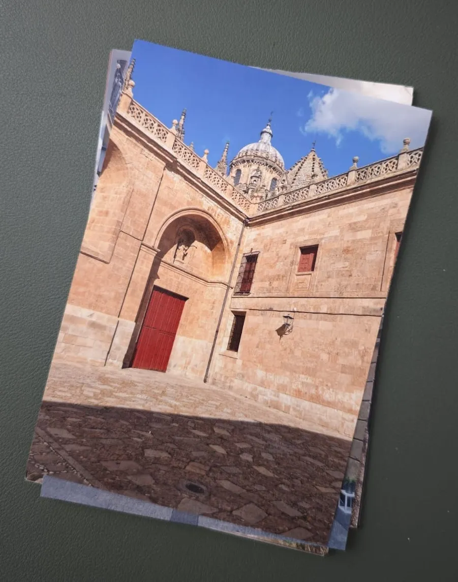 A physical travel print showing a historic red doorway.